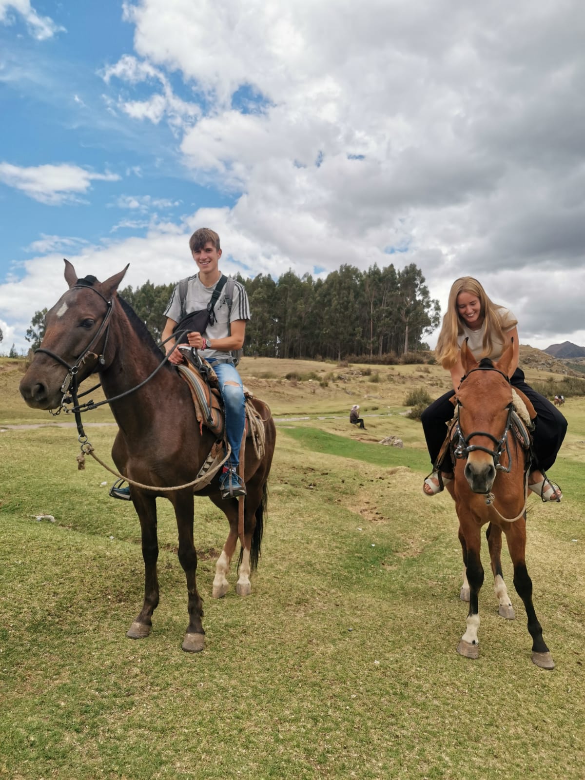 Riding horses over the sunny Cusco hills