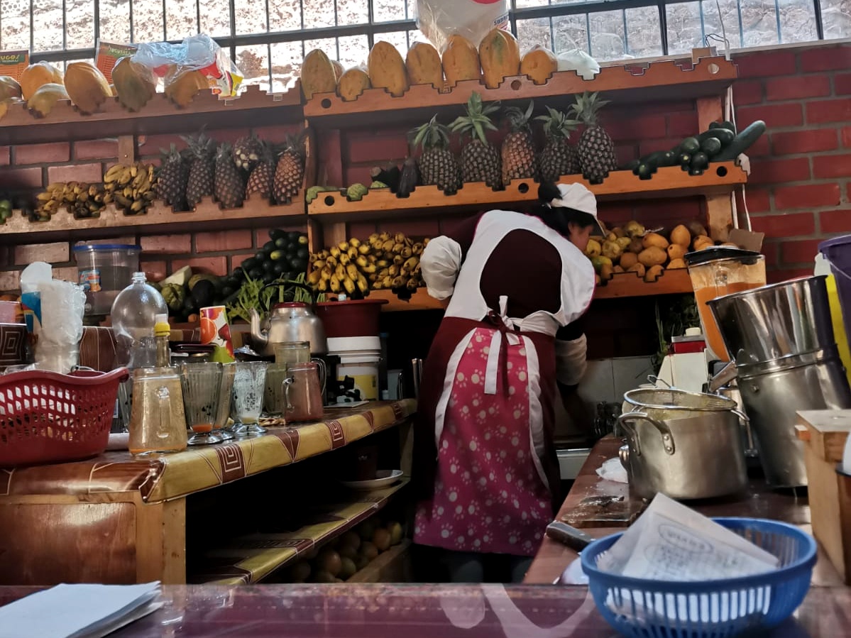 A woman making smoothies in the fruit market
