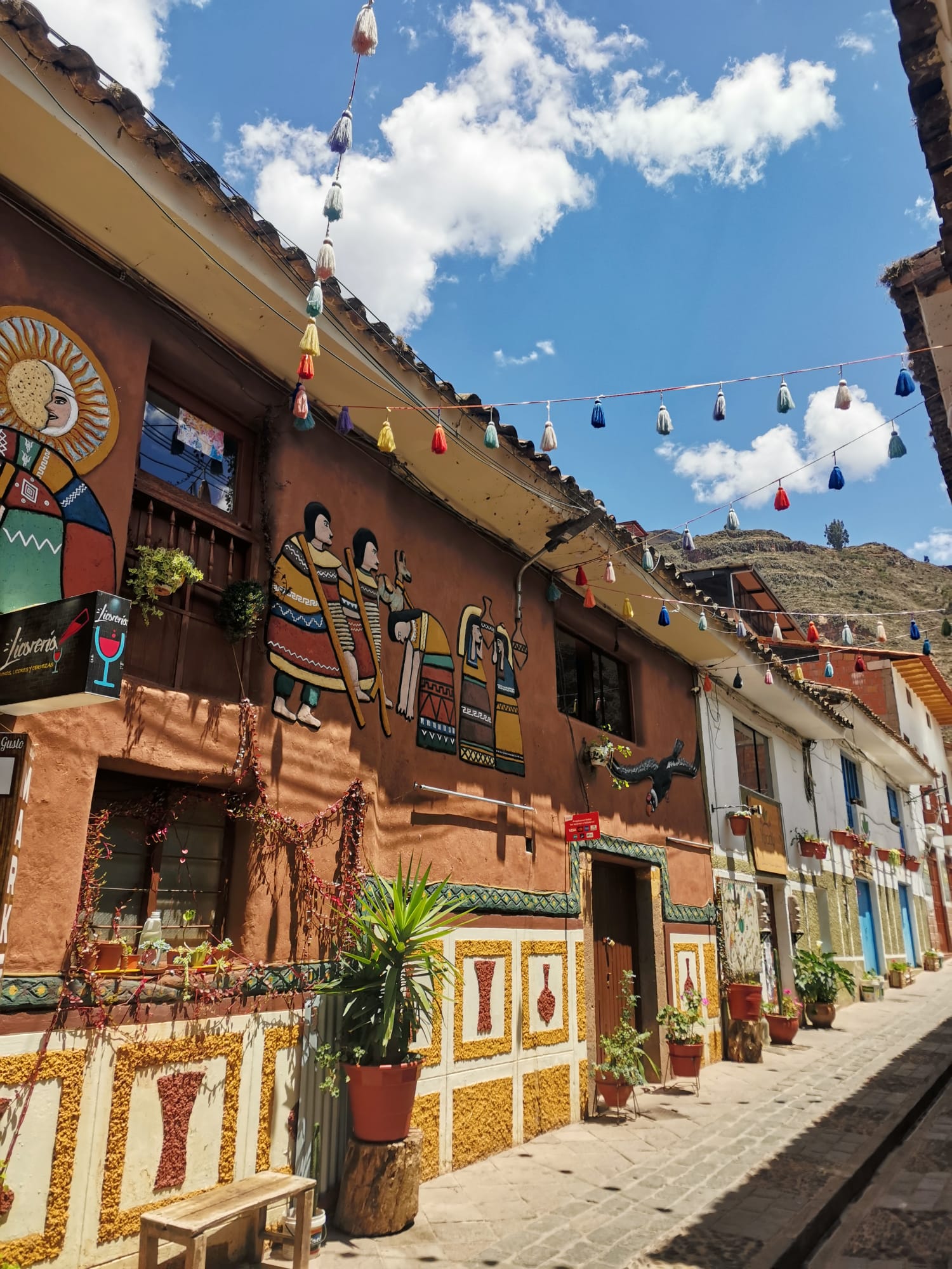 Narrow street lined with flags and bunting in Pisac