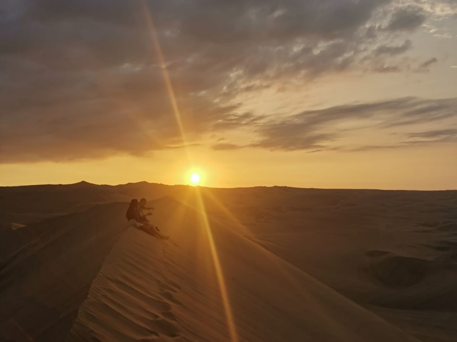 Sunset and sand dunes at Huacachina